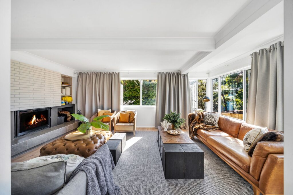 Cozy living room at Akora House with leather sofa and fireplace
