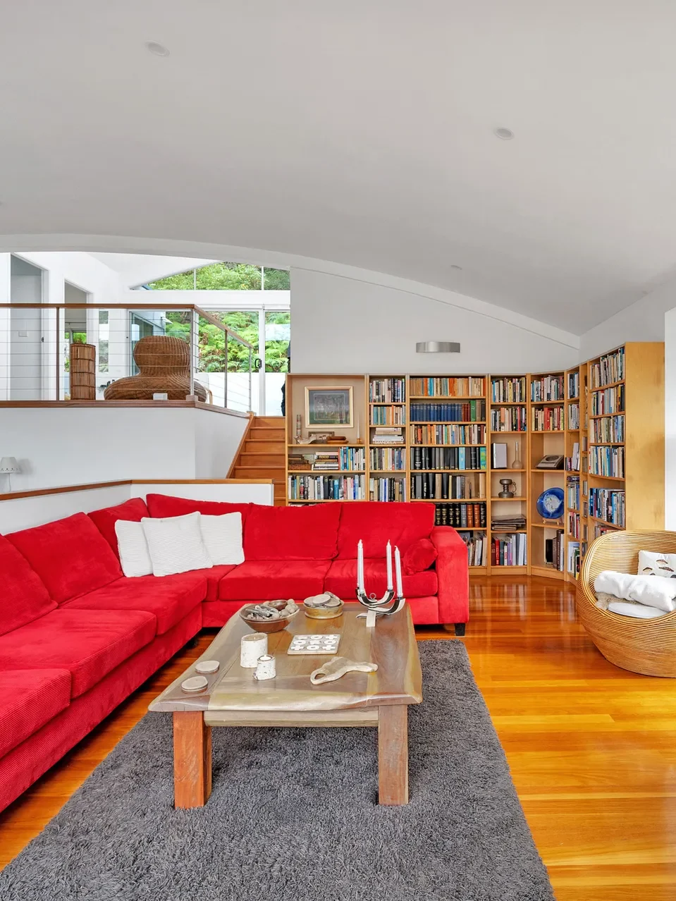 Living room with red sectional sofa and bookshelves at Bayview