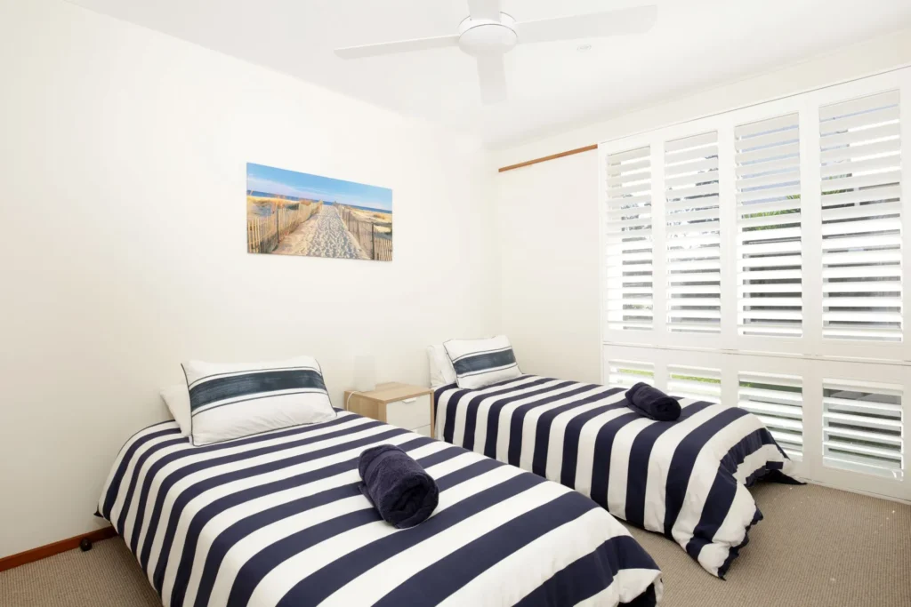 Twin bedroom with coastal stripes at Beach Street Residence, Huskisson