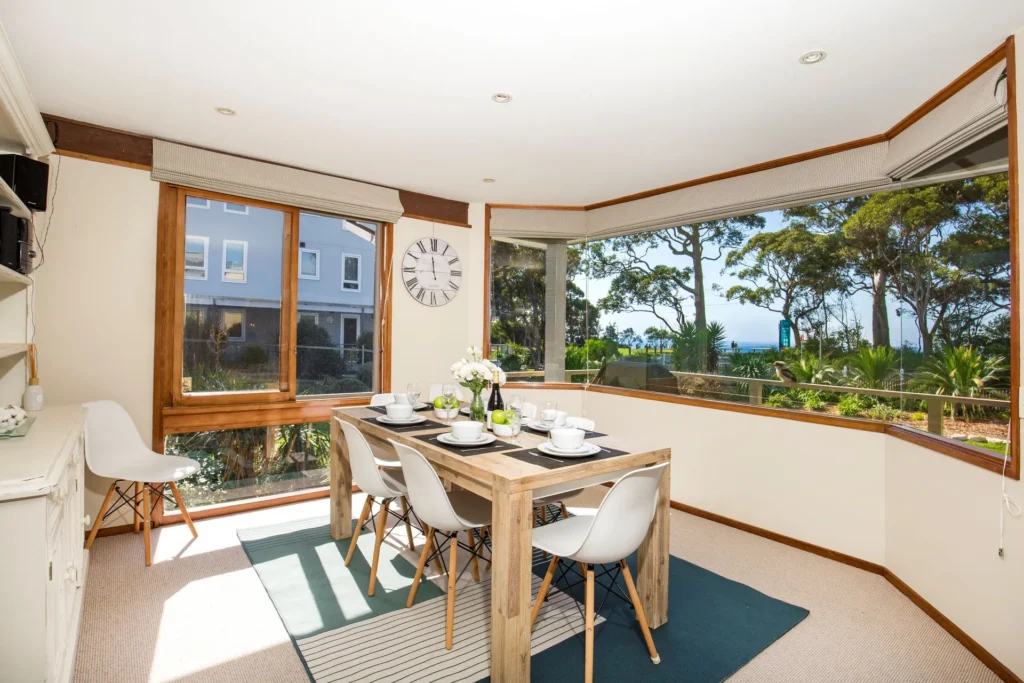 Sunlit dining room with scenic views at Beach Street Residence, Huskisson