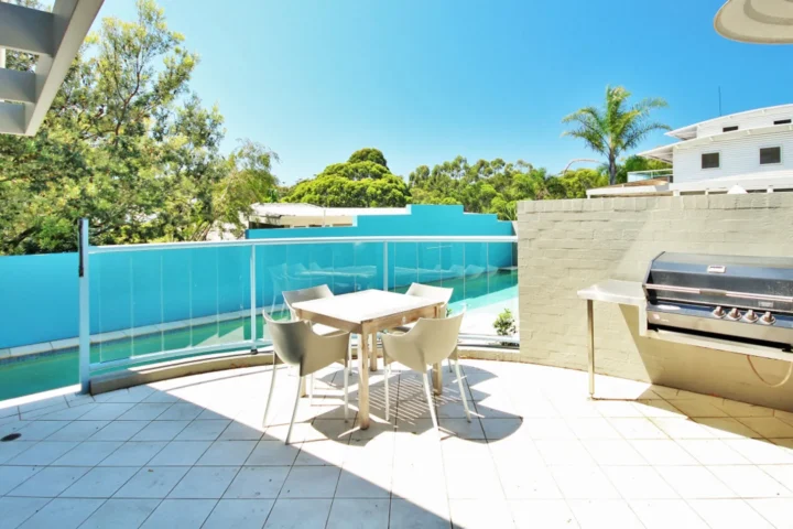 Outdoor deck with BBQ and dining area at Beachdaze at Hyams Beach