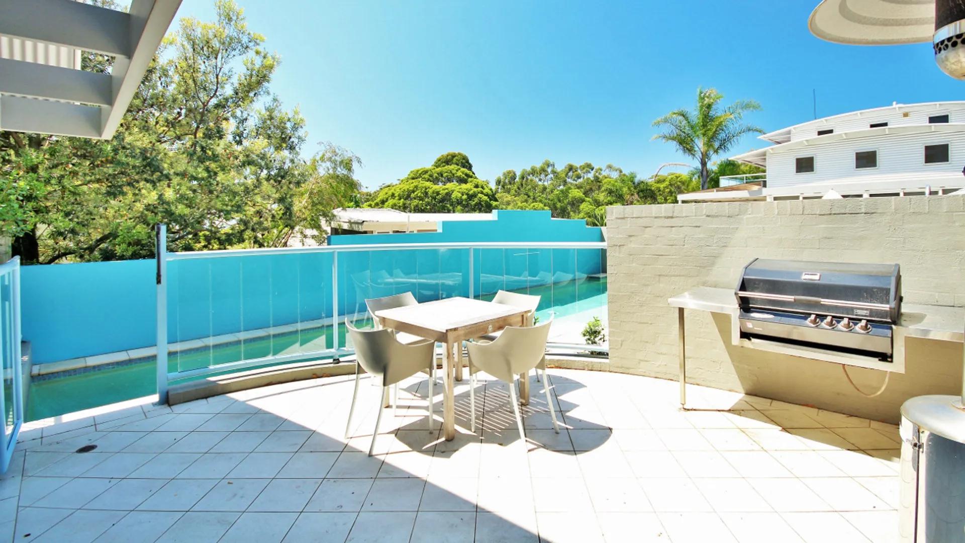 Outdoor deck with BBQ and dining area at Beachdaze at Hyams Beach