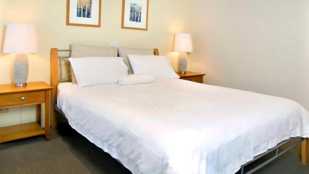 Cozy master bedroom with soft lighting at Beachdaze at Hyams Beach