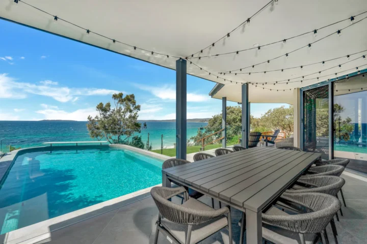 Outdoor pool and dining with bay views at Bellevue at Hyams Beach