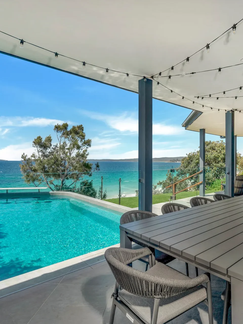 Outdoor pool and dining with bay views at Bellevue at Hyams Beach