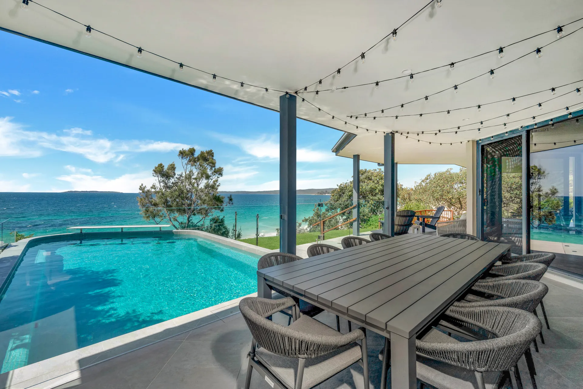 Outdoor pool and dining with bay views at Bellevue at Hyams Beach