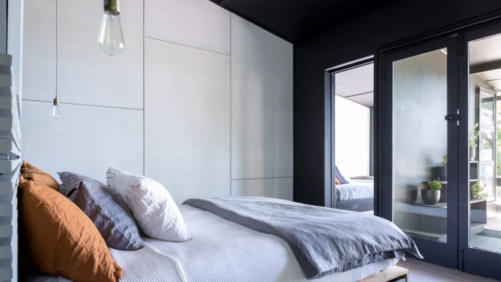 Modern bedroom at Black Shack on Hyams Beach with sleek dark walls