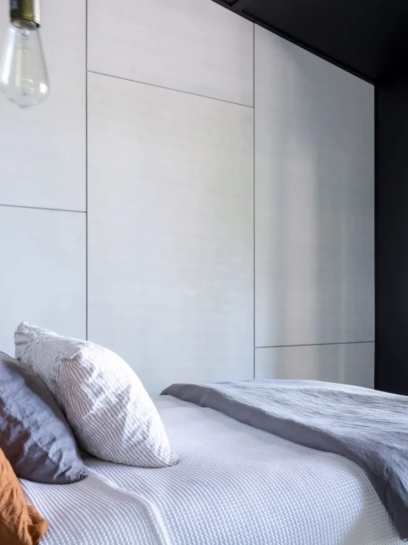 Modern bedroom at Black Shack on Hyams Beach with sleek dark walls