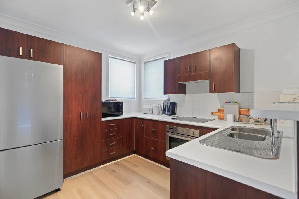 Wooden kitchen with white counters at Coastal Cove, Huskisson
