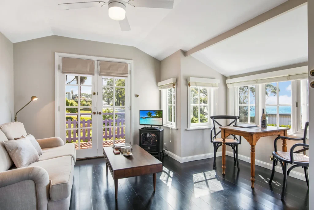 Cozy lounge with garden access at Cottage 1 at Hyams Beach