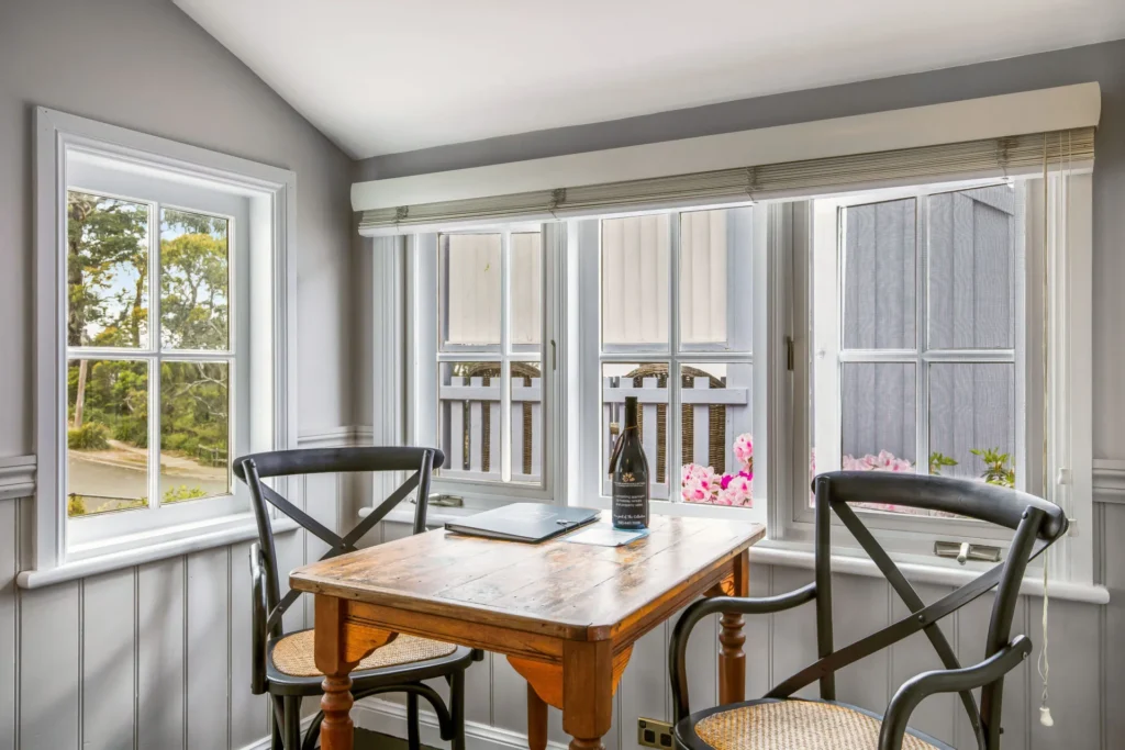 Sunny dining nook with a wooden table at Cottage 2 at Hyams Beach
