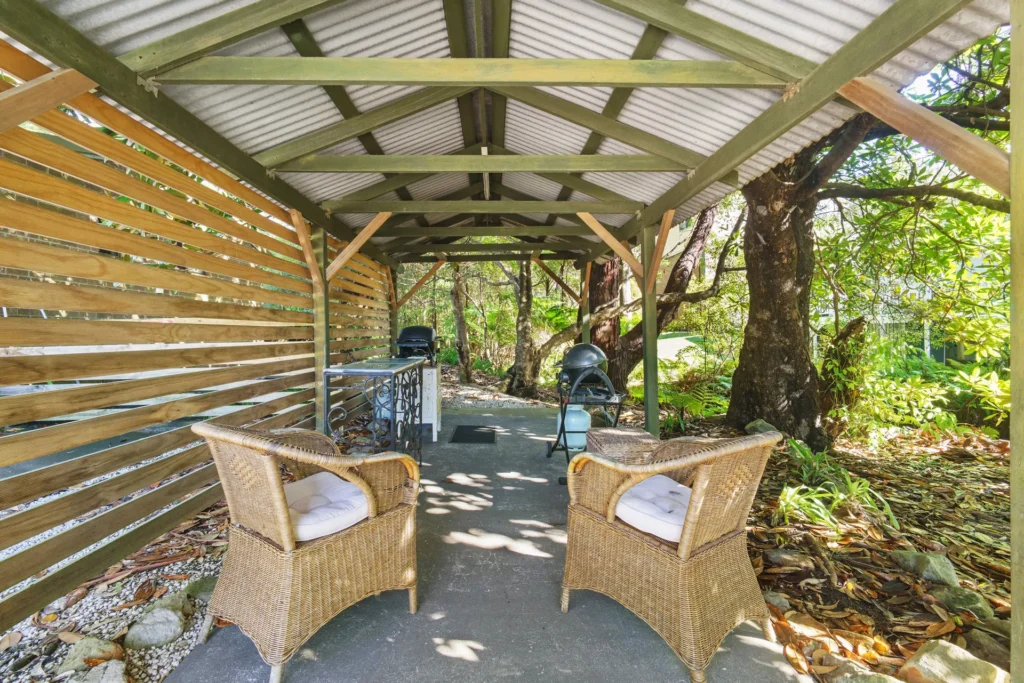 Covered garden seating and BBQ area at Cottage 2 at Hyams Beach