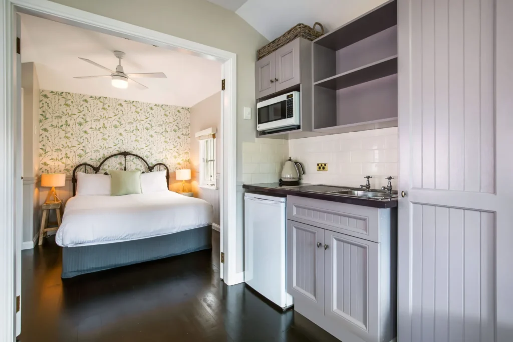 Studio kitchen and elegant bedroom at Cottage 3 at Hyams Beach