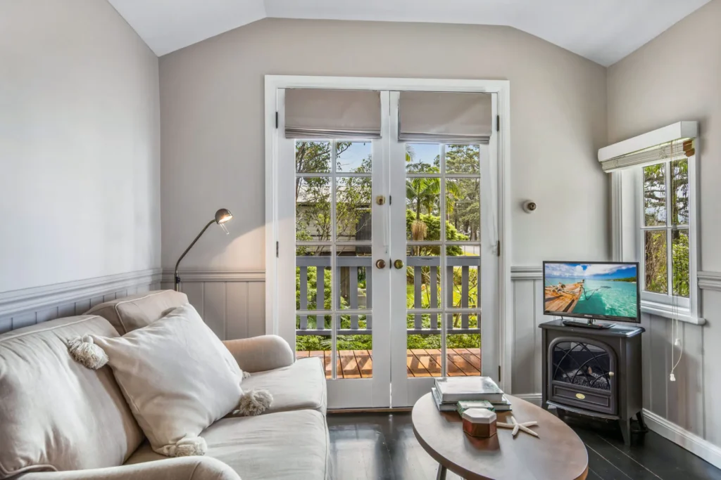 Cozy lounge with garden terrace access at Cottage 3 at Hyams Beach