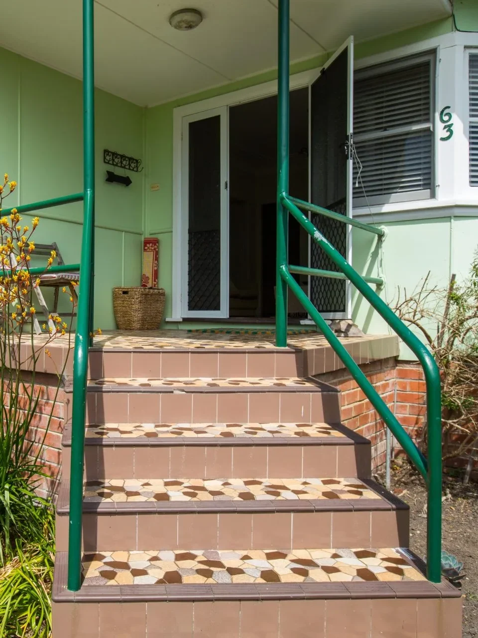 Retro green exterior and tiled steps at Fibro Majestic at Hyams Beach