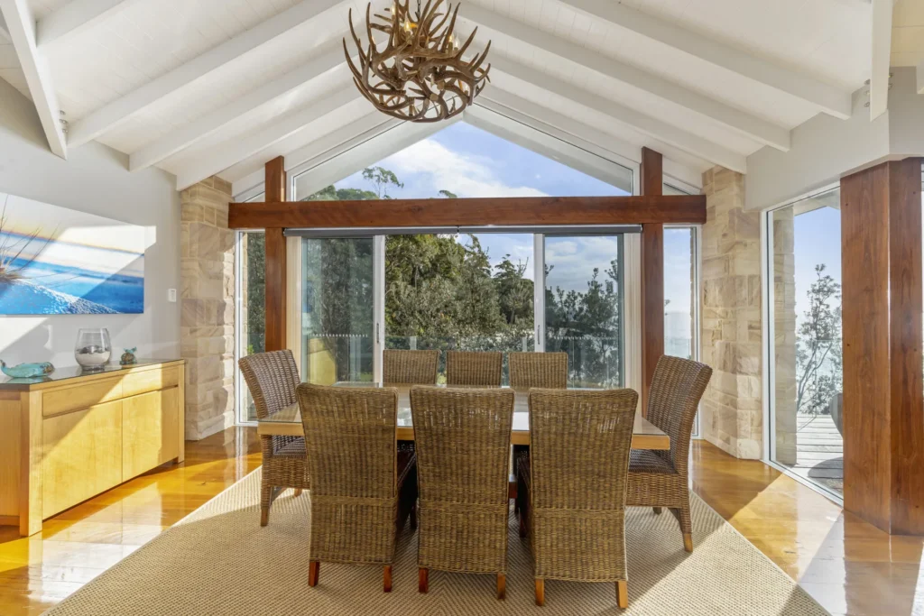 Wicker dining set with stone accents at Horizons at Hyams Beach