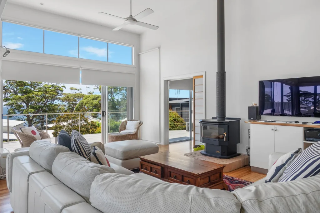 Airy living room at Hyams Reflections with fireplace and balcony
