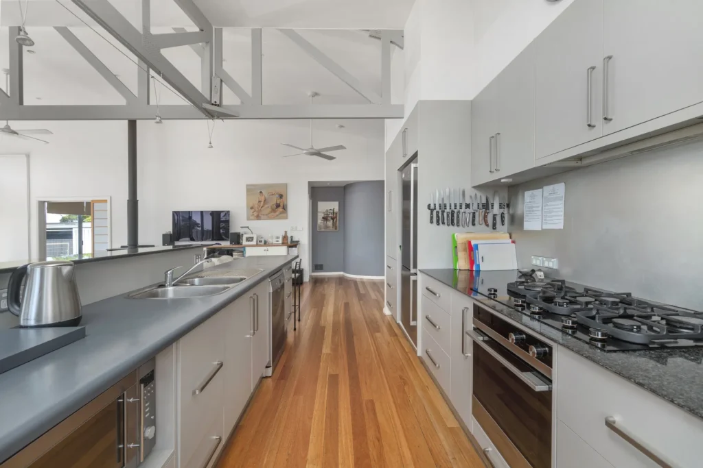 Modern galley kitchen at Hyams Reflections with sleek grey cabinets
