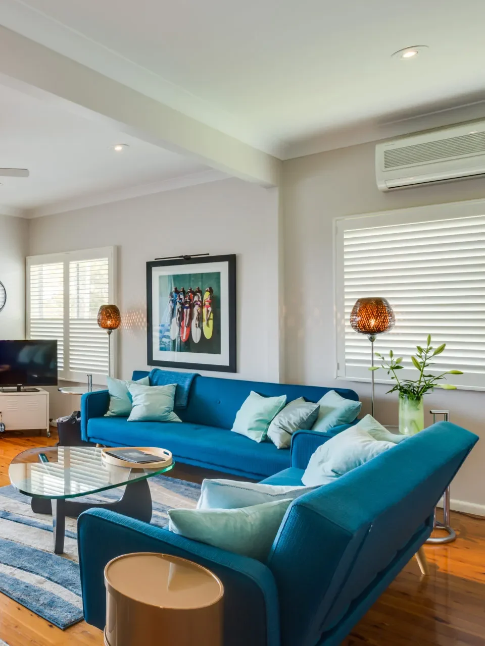 Living area with blue sofas and balcony access at Nautilus at Hyams Beach