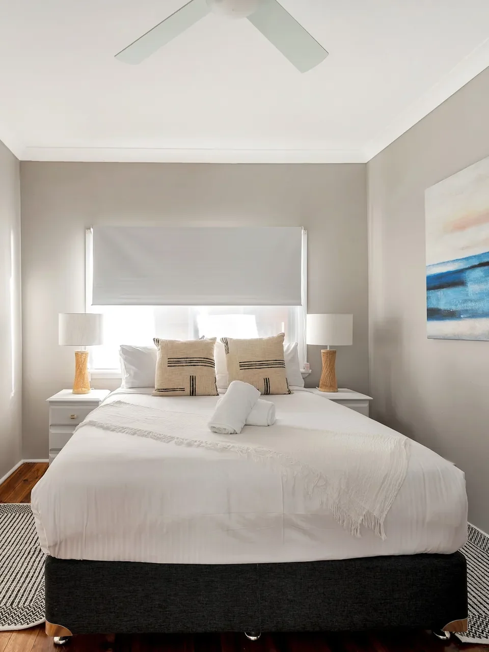 Modern bedroom with ensuite and coastal art at Scarborough