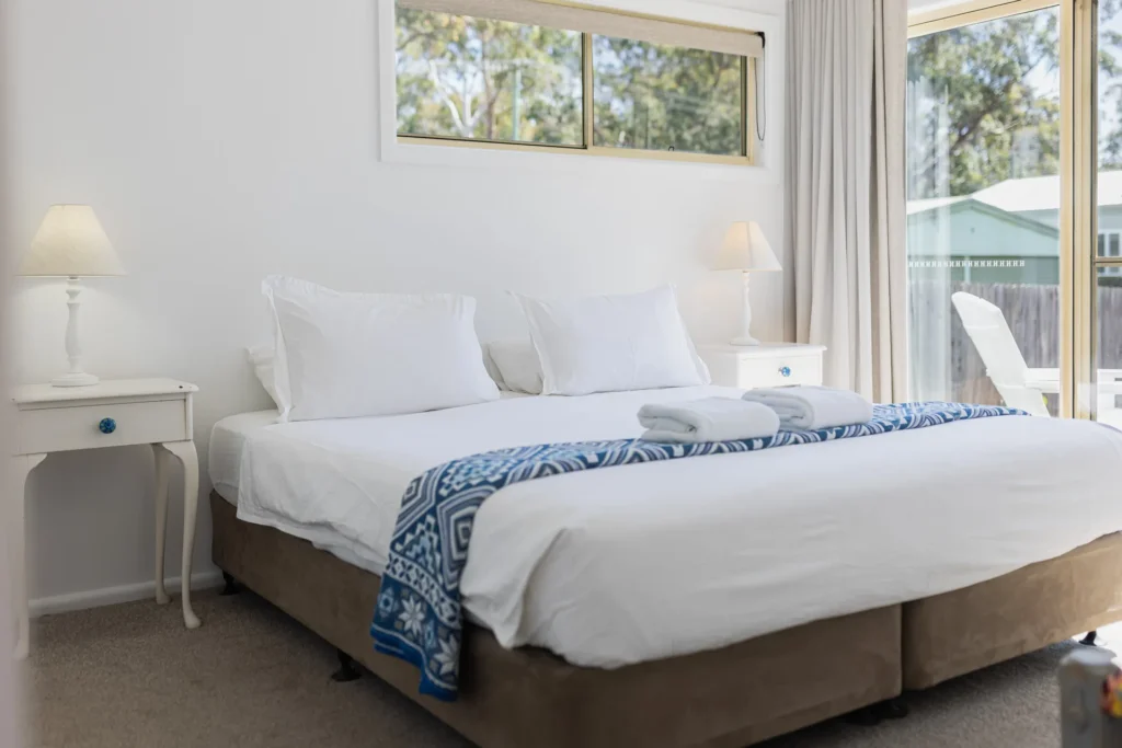Serene bedroom with blue accents at Tapalla Point, Huskisson