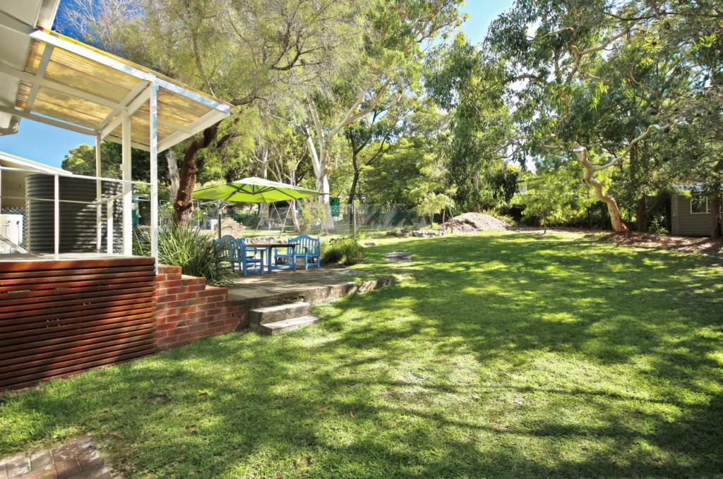 a spacious backyard with secluded surroundings