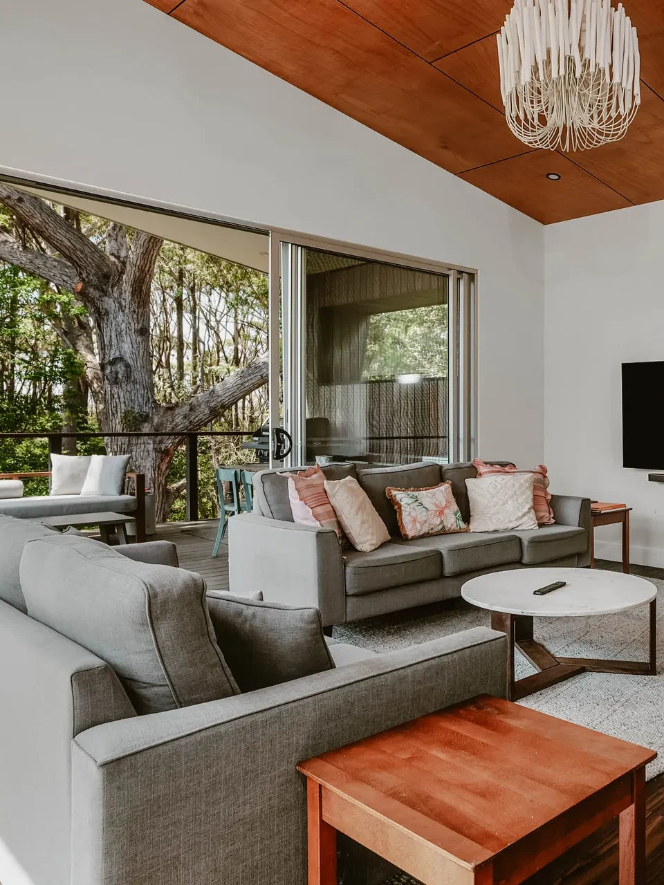 large living room with elegant furniture, looking at the scenic forest view.