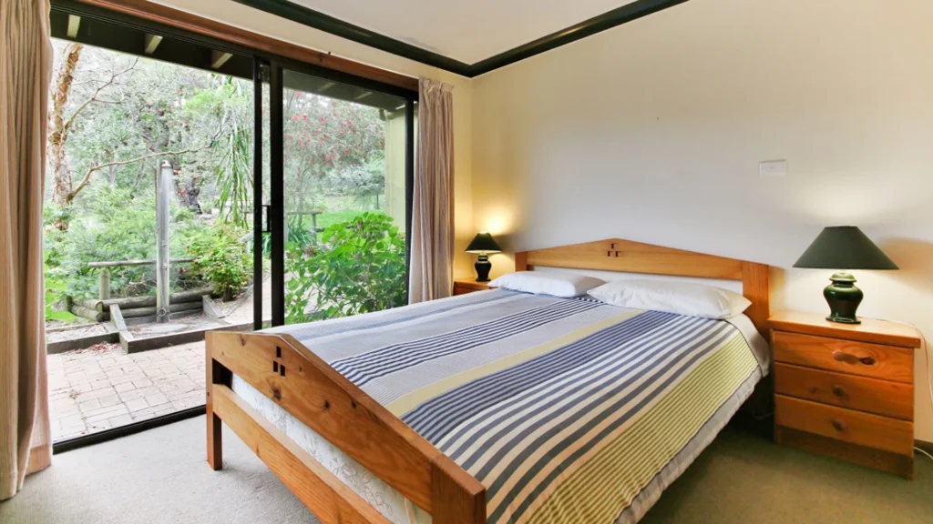 a queen size bed with open air balcony