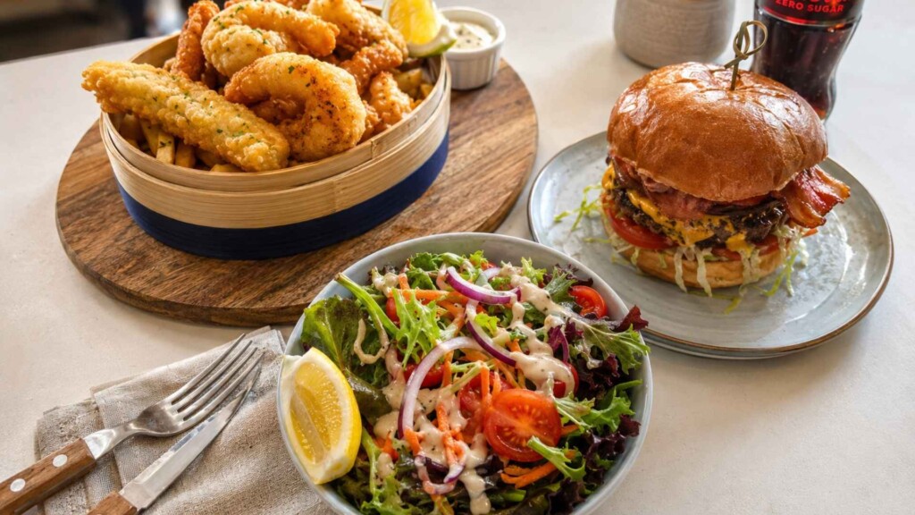 the salty carb serving a burger, fresh salad and crunchy fried snacks