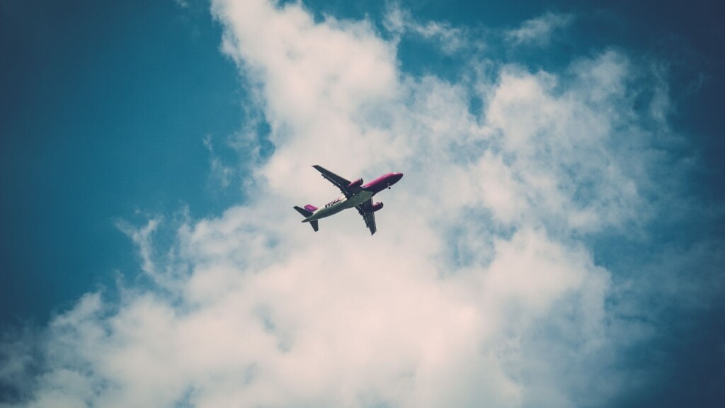 Airplane flying from Sydney to Vincentia over cloudy sky