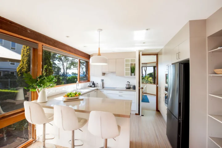 Kitchen with island and stools in Beach Street Residence, Huskisson