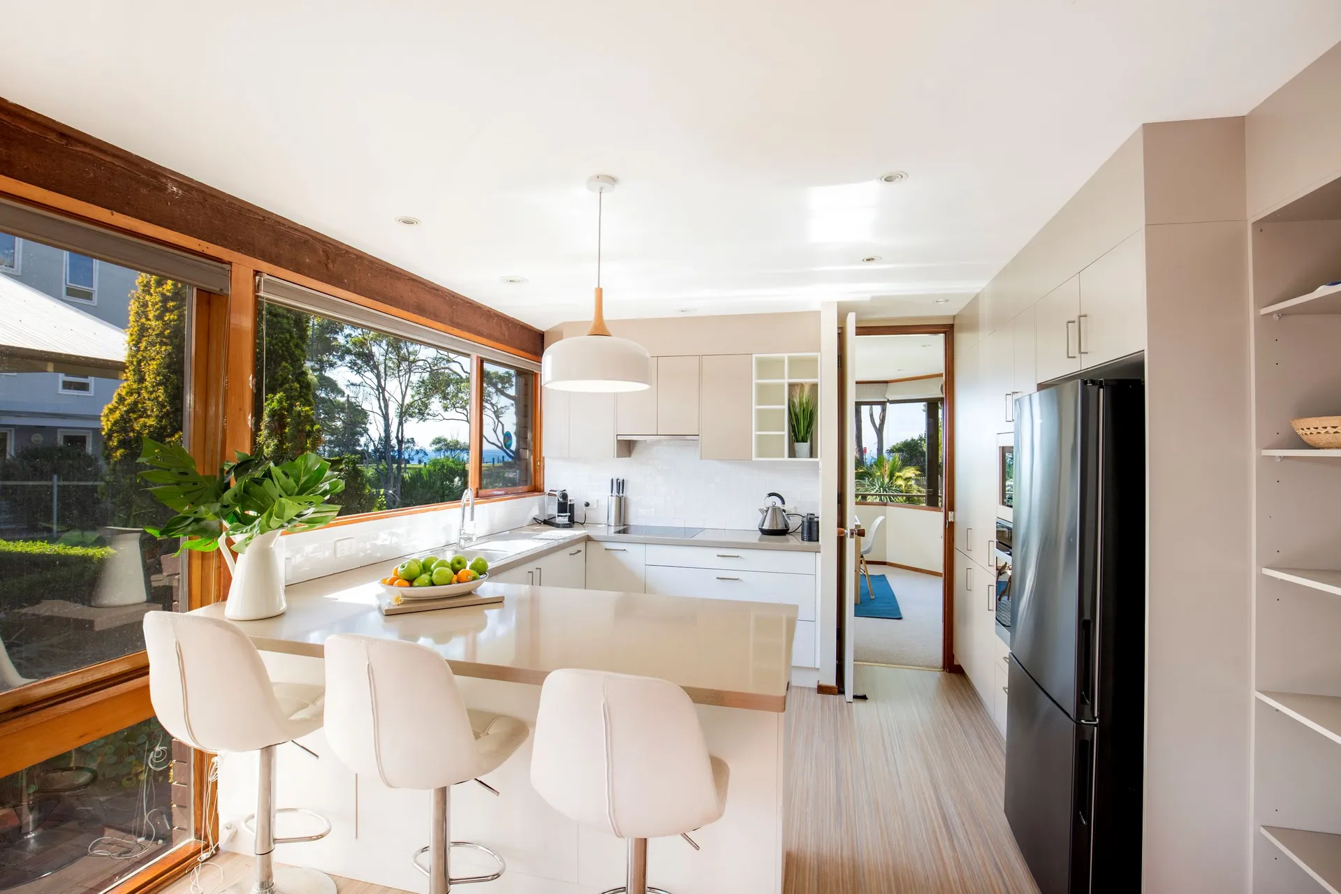 Kitchen with island and stools in Beach Street Residence, Huskisson