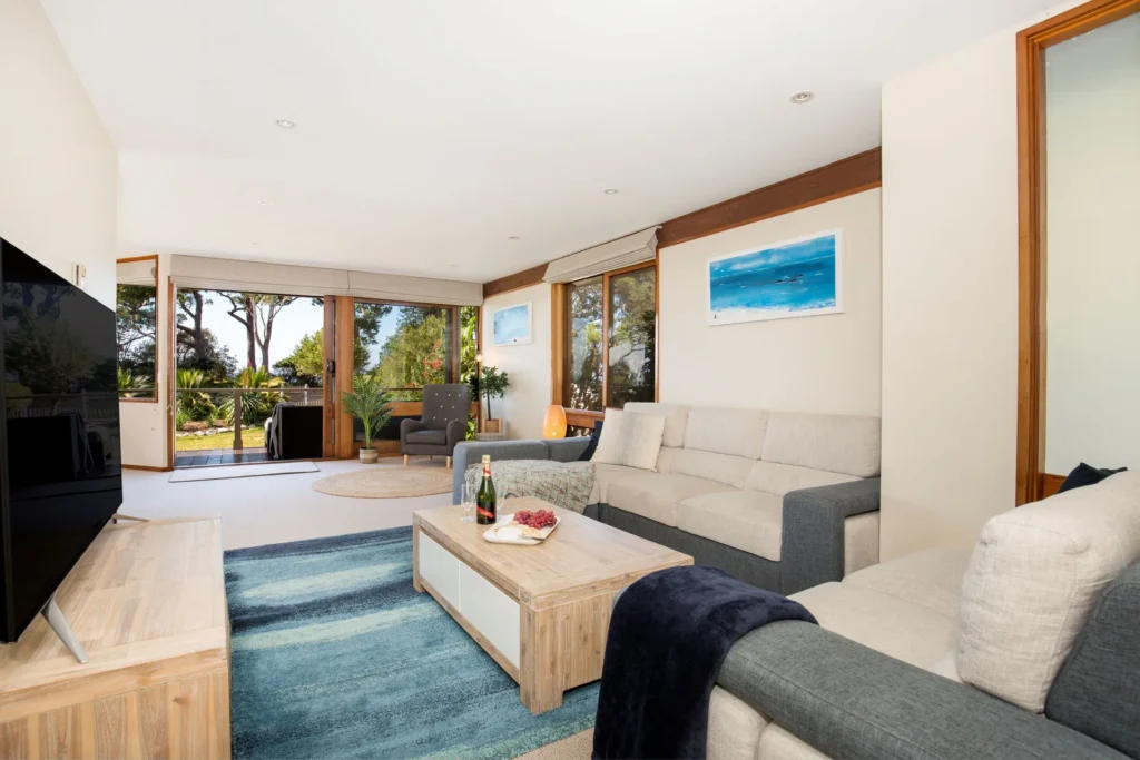 Living room with sofa and garden view in Beach Street Residence, Huskisson