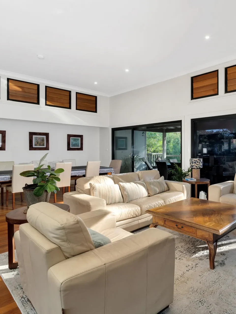 Cream sofas and wooden table in Elouera at Greenfields Beach