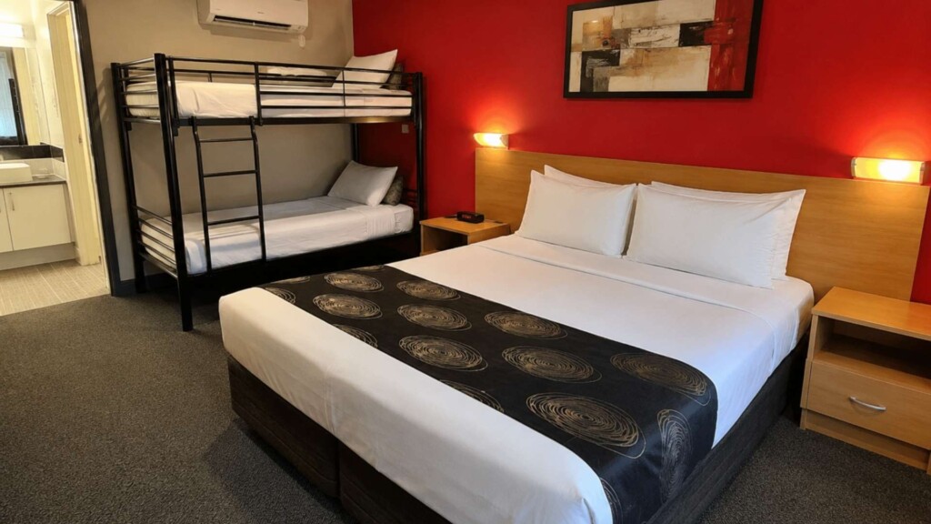 Family accommodation room featuring a queen bed and bunk beds for up to four guests