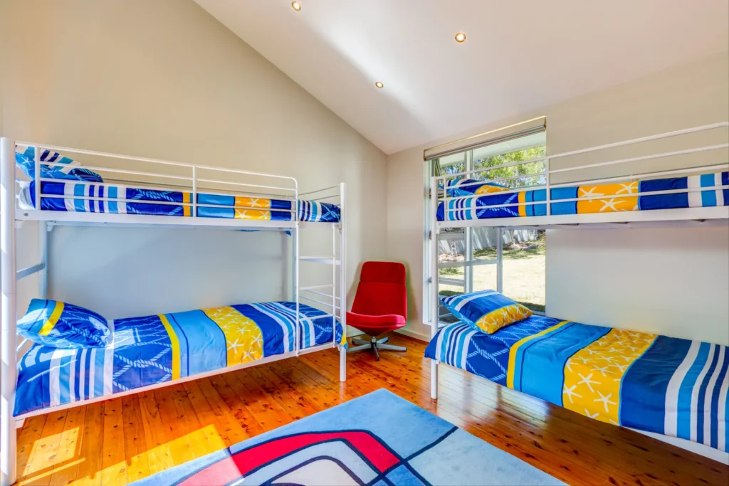 Bunk beds and red chair in Harlequin Beach House, Vincentia