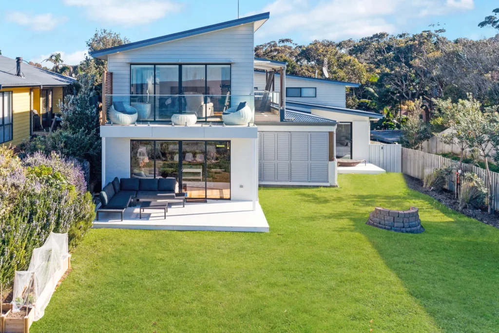 Modern beach house with a sunny lawn at Beach Perfect, Culburra Beach