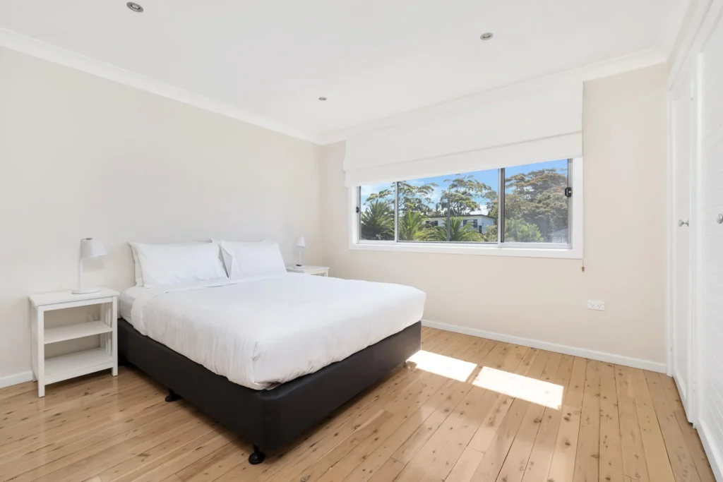 Airy sunlit bedroom with timber floors at Sea Dream, Culburra Beach