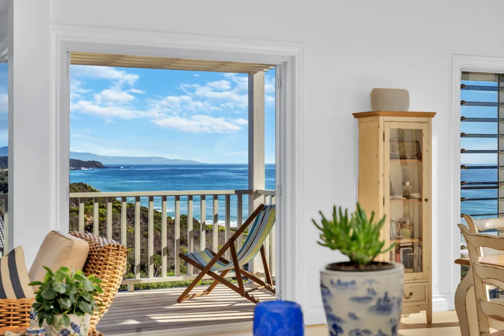 Bright coastal living area with balcony views at The Cape, Culburra Beach