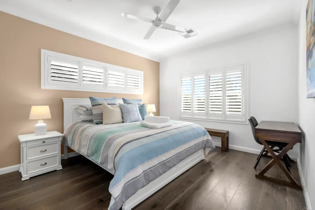 airy bedroom with multiple windows