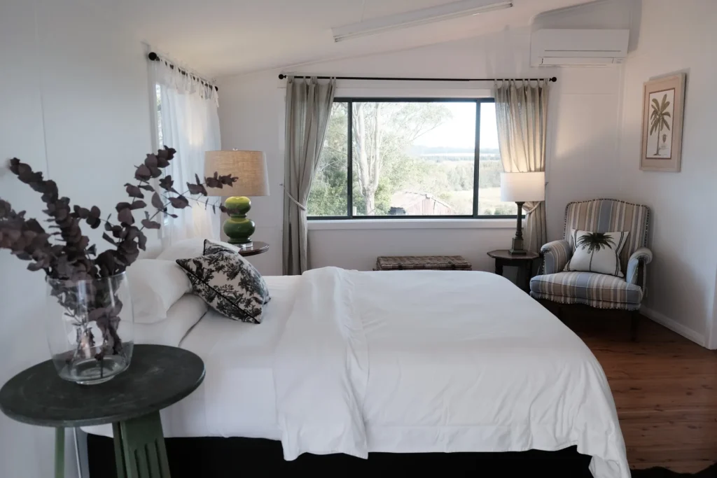 bright bedroom framed by large windows