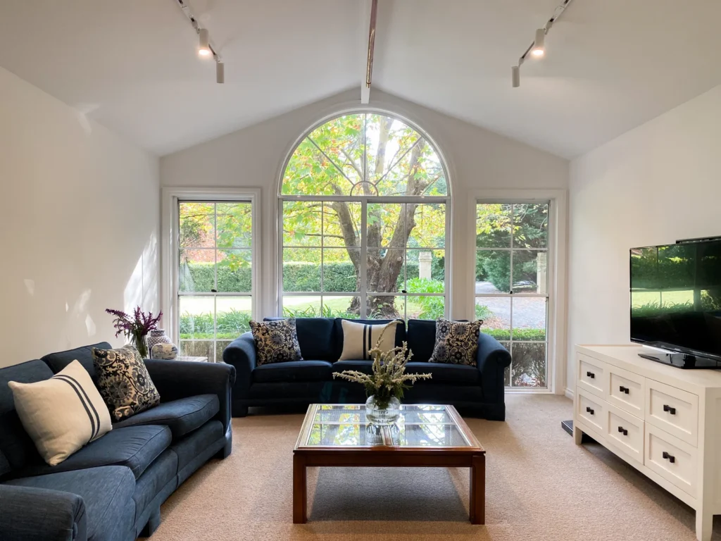 cosy living room framed by large windows